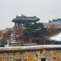 a snow covered roof of a building with a tower