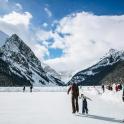 a group of people skiing in the snow in the mountains