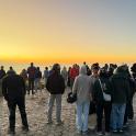 a large group of people standing on top of a mountain