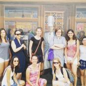 a group of people standing in front of a painting