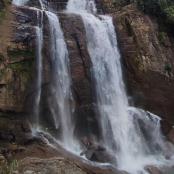 a waterfall on the side of a rocky cliff