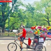 a man riding a bike with a cart