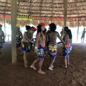 a group of women in bathing suits on a beach