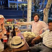 a group of people sitting at a table with drinks