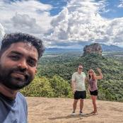 a man and a woman standing on top of a mountain