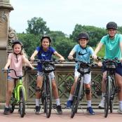 a group of children on bikes on a bridge