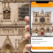 a person holding a cell phone in front of a building