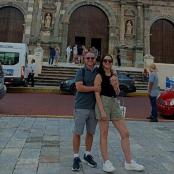 a man and a woman standing in front of a building