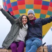 a man and woman sitting on a hot air balloon