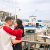 a man and a woman standing next to a marina