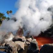 a pile of steam coming out of a fire with rocks