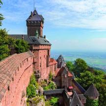 eine Burg auf einem Hügel mit einem Uhrturm