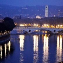 a bridge over a river with a city at night