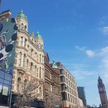 a tall building with a clock tower in the background