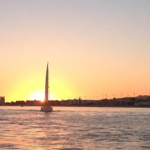 a boat in the water with a sunset in the background