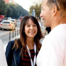 a woman talking to a man on the street