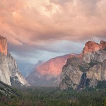 a view of a valley between two large rocky mountains
