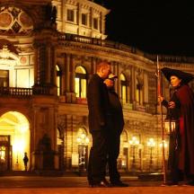a man and a woman standing in front of a building
