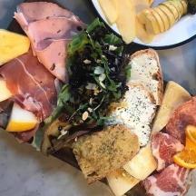 a sandwich with meat and vegetables on a table