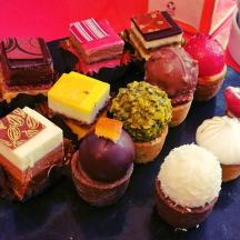 a plate of different types of cakes and pastries