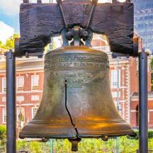 a large bronze bell in front of a building
