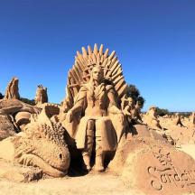 a sand sculpture of a statue of a dragon