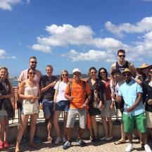 a group of people posing for a picture on a fence