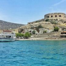 a boat in the water in front of a castle