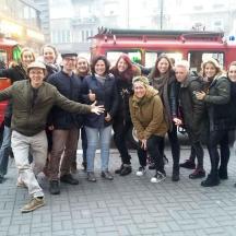 a group of people posing in front of a red van