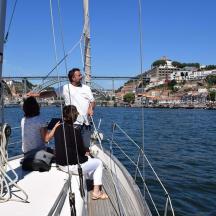 a man and two people on a boat in the water