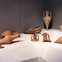 a group of pottery on display in a museum