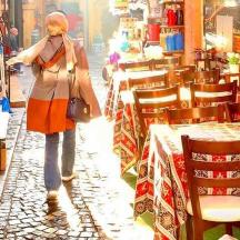a woman is walking down a street