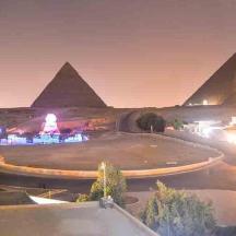 a view of the pyramids of giza at night