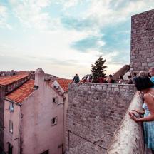 a group of people standing on top of a wall