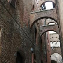 an old brick building with arches on the side of it