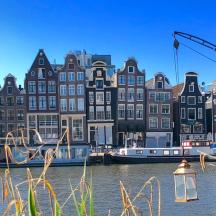a group of buildings on a canal with boats