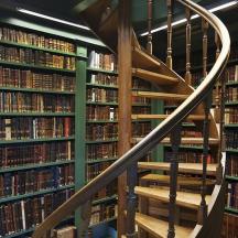 a staircase in a library filled with books