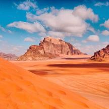a desert scene with rocks and sand in the foreground