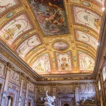a room with a ceiling with paintings on it