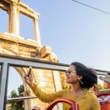 a woman sitting on a bus looking at her cell phone