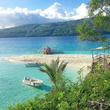 two boats on a beach in the water
