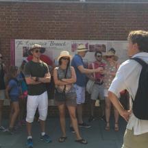 a group of people standing in front of a brick wall