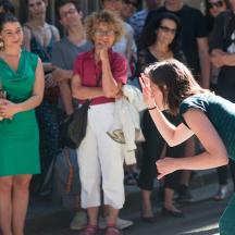 a woman standing in front of a crowd of people