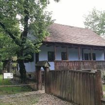 a house with a wooden fence in front of it