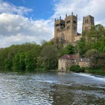 a castle sitting on a hill next to a river