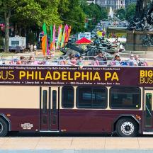 a bus driving down a street with people on it