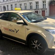 a white car with a free now sticker on it