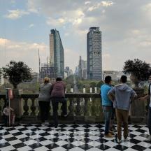 a group of people standing on a checkered floor