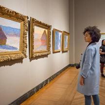 people standing in an art museum looking at paintings