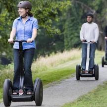 a group of people riding segways down a path